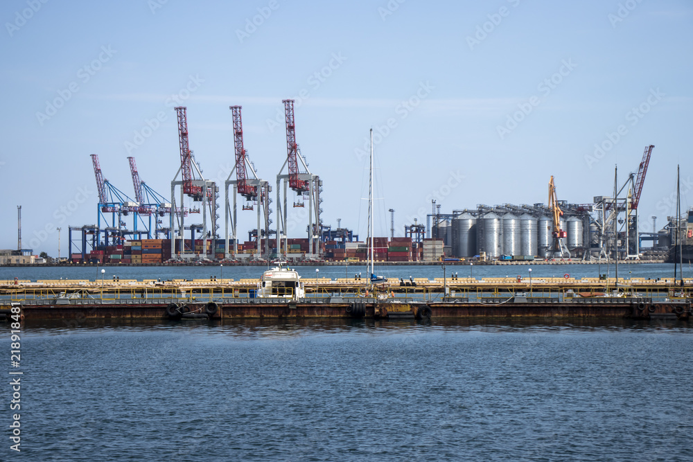 cargo port by the sea with large forklifts and cranes that ship containers to ships