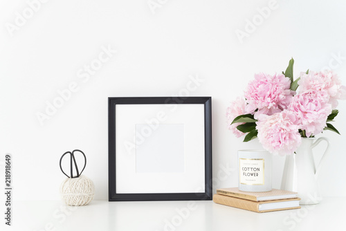 Fototapeta Naklejka Na Ścianę i Meble -  White portrait frame mock up with a pink peonies beside the frame, overlay your quote, promotion, headline, or design, great for small businesses, lifestyle bloggers and social media campaigns. poster