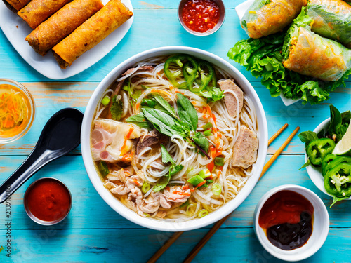 colorful vietnamese pho bo with beef and spring rolls