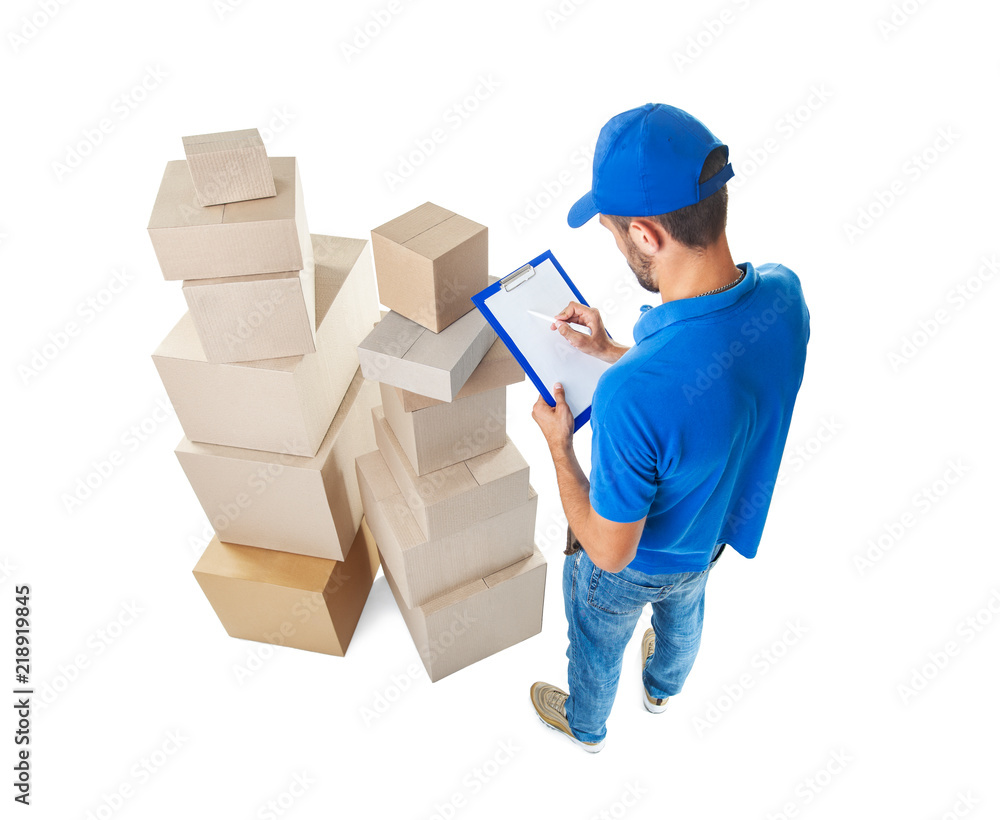 Top view of delivery man taking notes near stack of parcels boxes Top view of delivery man taking notes near stack of parcels boxes