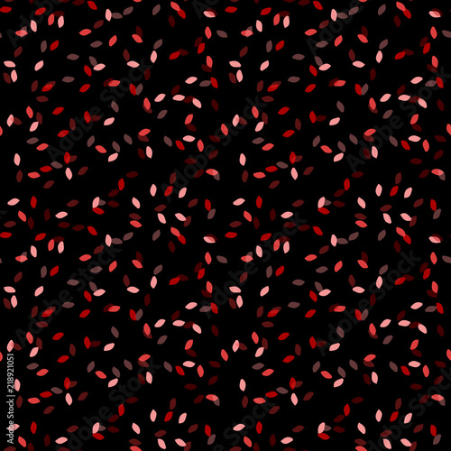 Elegant black seamless pattern with chaotic sparks in different shades of red and pink