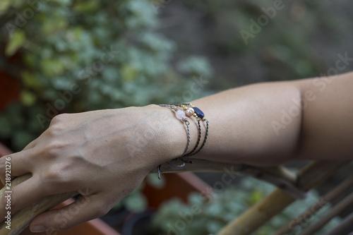 Female hand wrist resting with tiny jewelry