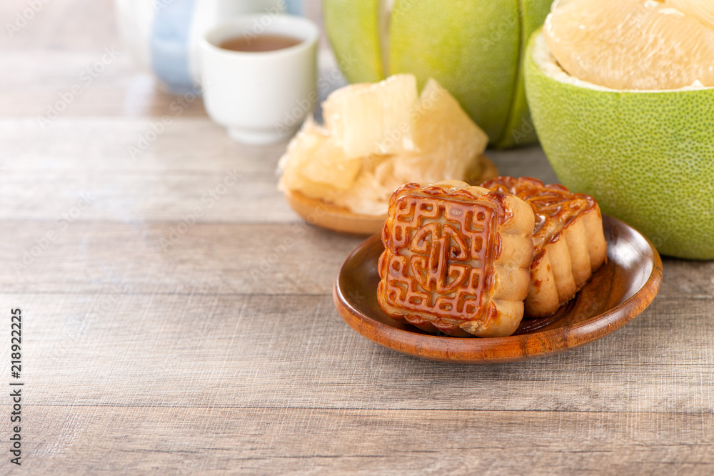 fresh and peeled pomelo(shaddock), grapefruit with slices and mooncake in mid-autumn festival(moon festival) fresh and peeled pomelo(shaddock), grapefruit with slices and mooncake in mid-autumn festival(moon festival)