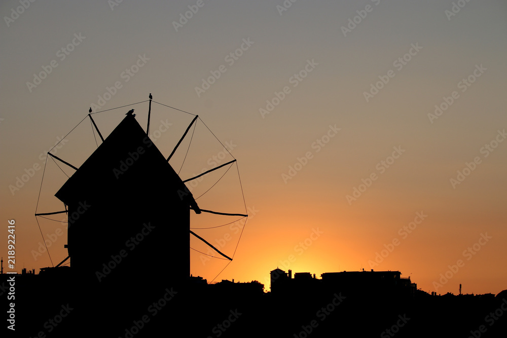 Old windmill sunset cityscape Nessebar Bulgaria