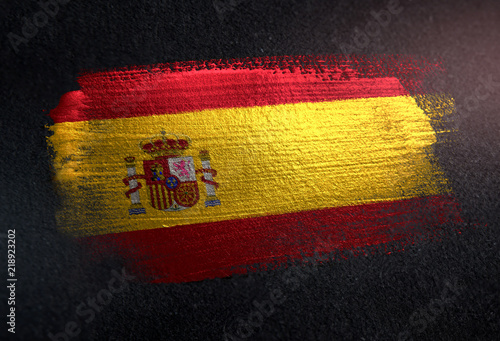 Spain Flag Made of Metallic Brush Paint on Grunge Dark Wall photo