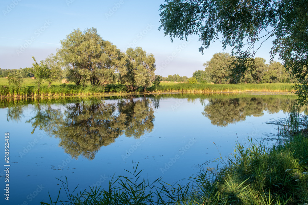 A peaceful river landscape at summer sunset.Late afternoon.