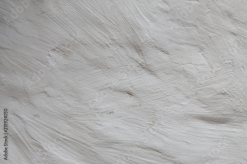 White limed wall with rough uneven  texture as background. Ecology concept