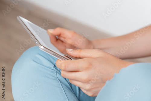 woman holding digital tablet, closeup