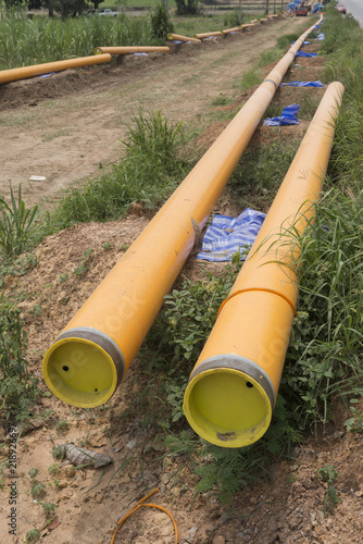Yellow PVC Drainage Pipe on a Construction Site .plastic pipe transfer water system aligned on site.Roll pvc tube at work site.