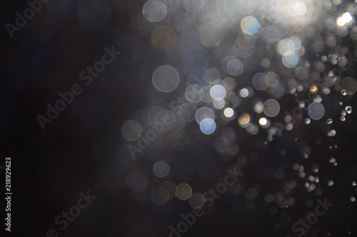 bokeh of water fly and lights on black background,