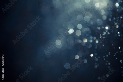 bokeh of water fly and lights on black background,