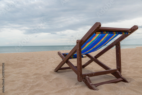 Beach chair on the sand with sea and sky © pandaclub23
