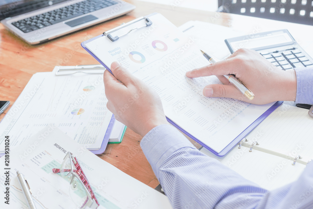 Administrator business man financial inspector and secretary making report, calculating or checking balance. Administrator business man financial inspector and secretary making report, calculating or checking balance.