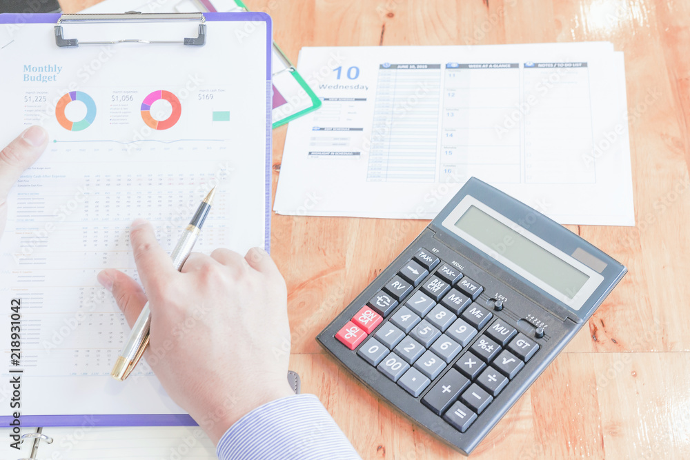 Administrator business man financial inspector and secretary making report, calculating or checking balance. Administrator business man financial inspector and secretary making report, calculating or checking balance.