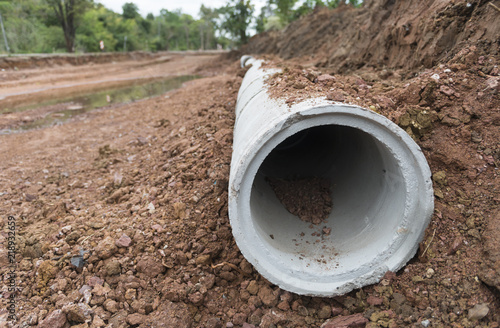 Wallpaper Mural Concrete Drainage Pipe row on a Construction Site near ditch. Concrete pipe stacked sewage water system aligned on site. Torontodigital.ca