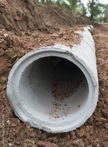 Close up of Concrete Drainage Pipe on a Construction Site .Concrete pipe stacked sewage water system aligned on site.