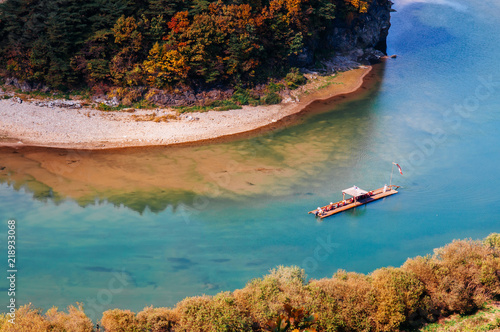 Boat rafting in Seogang river at Seonam village with autumn forest. Gangwon, South Korea photo