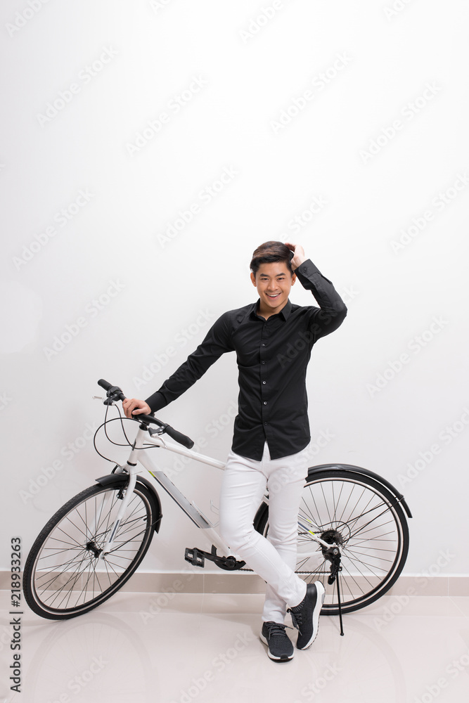 Portrait of a handsome man with bicycle in isolation Portrait of a handsome man with bicycle in isolation