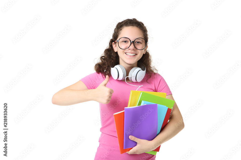 Young girl with notebooks and headphones on white background Young girl with notebooks and headphones on white background