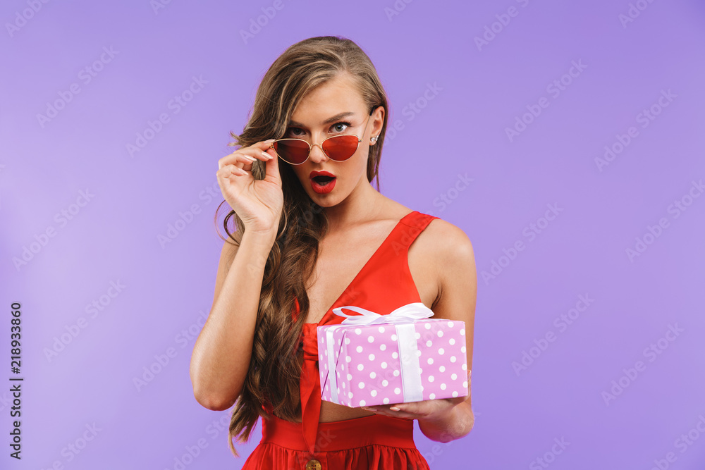 Portrait of a shocked young woman in red dress posing Portrait of a shocked young woman in red dress posing