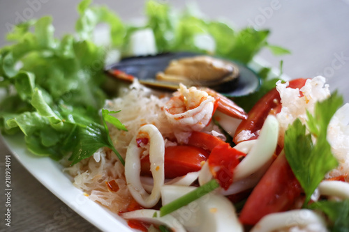Spicy seafood salad cooked by fresh seafood ingredient such as prawn, squid, mussel mixed with vegetables.