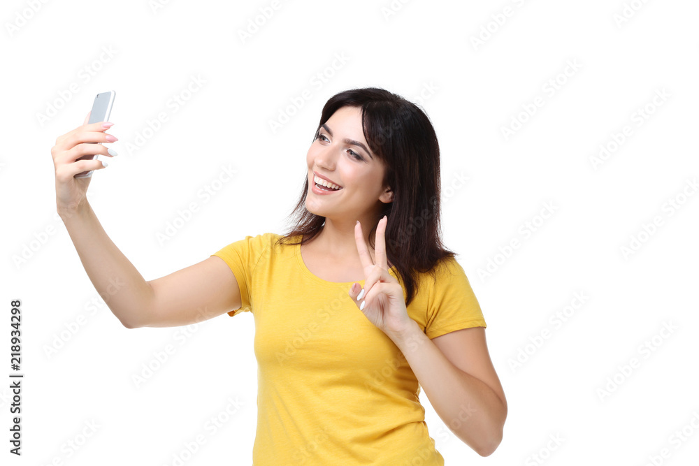 Young woman making selfie on white background Young woman making selfie on white background