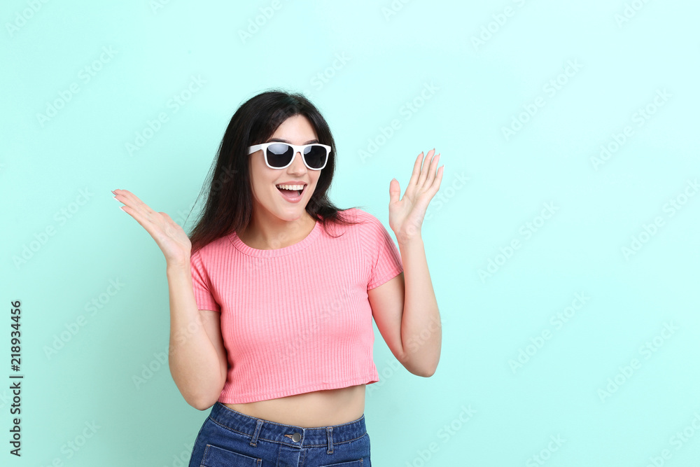 Young woman with sunglasses on mint background Young woman with sunglasses on mint background