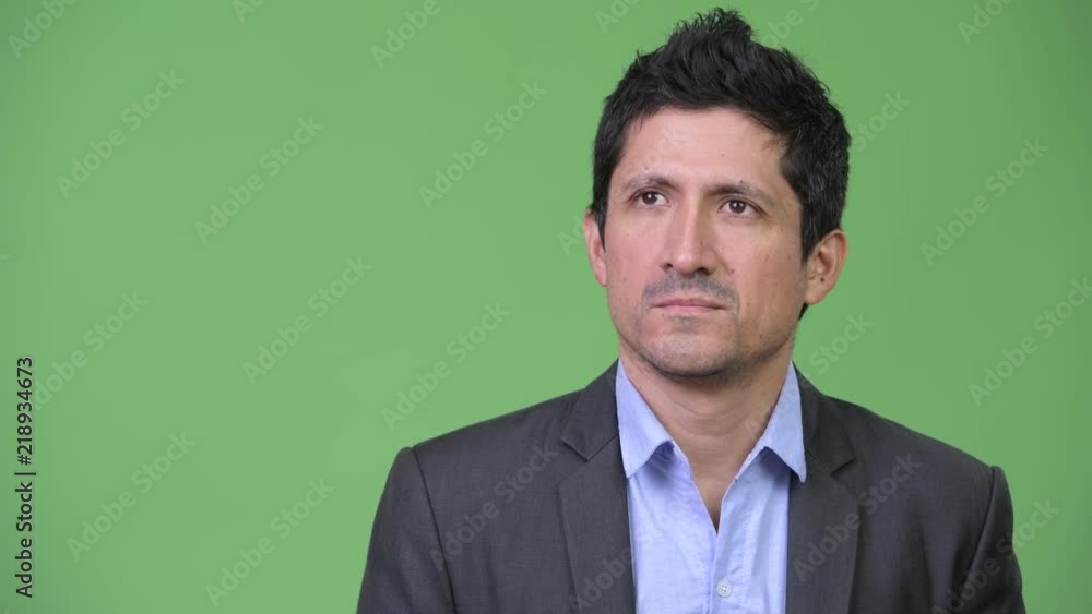 Hispanic businessman looking bored while thinking Hispanic businessman looking bored while thinking