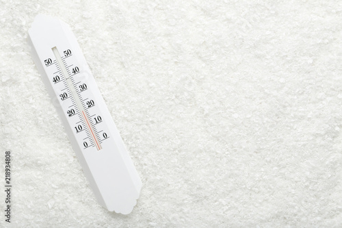 White thermometer in snow