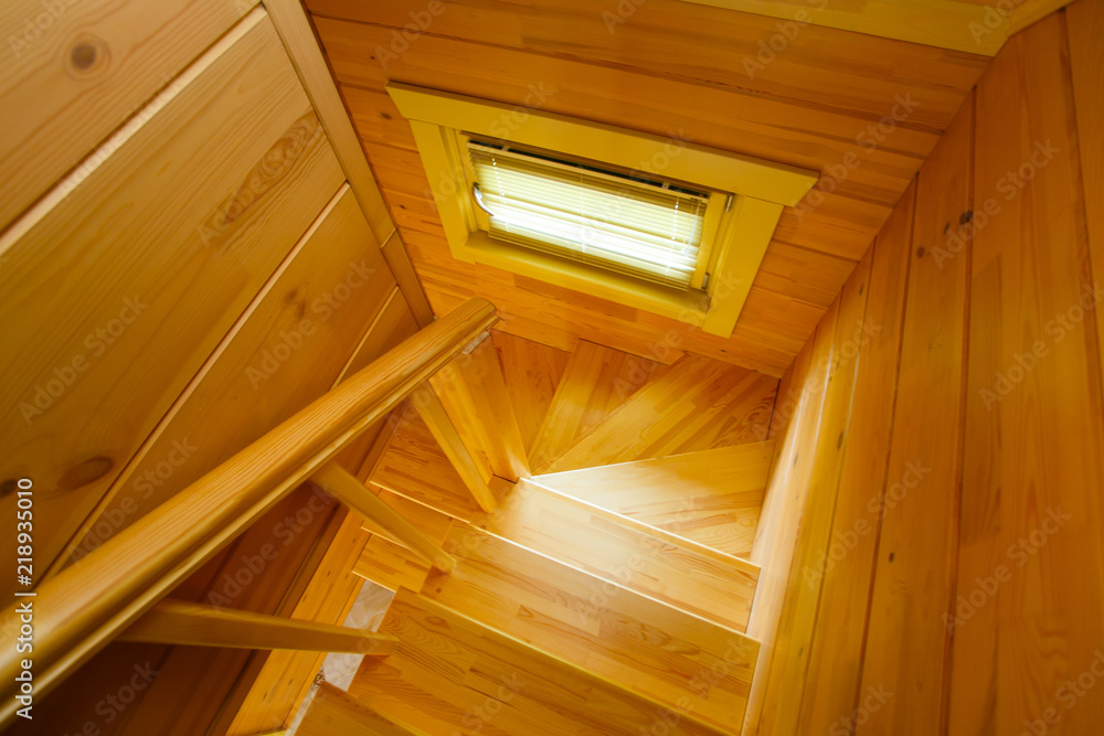 Bright wooden staircase, small window top view Bright wooden staircase, small window top view