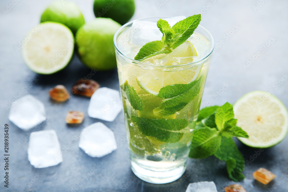 Mojito cocktail in glass on wooden table Mojito cocktail in glass on wooden table