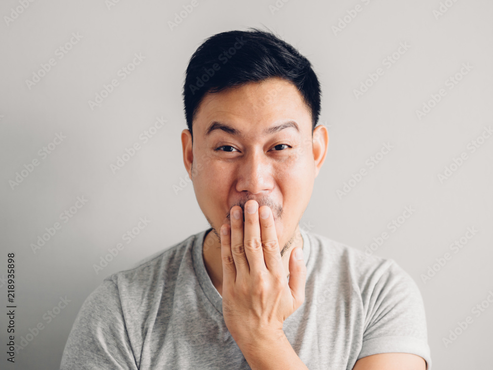 Headshot photo of Asian man with laugh face. on grey background. Headshot photo of Asian man with laugh face. on grey background.