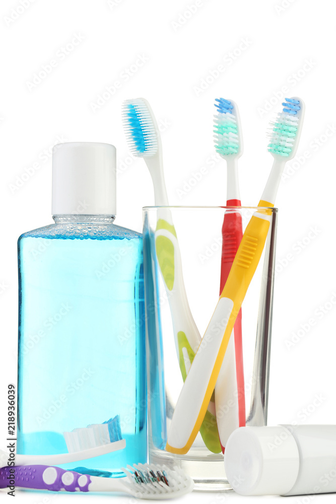 Toothbrushes in glass with mouthwash bottle on white background Toothbrushes in glass with mouthwash bottle on white background