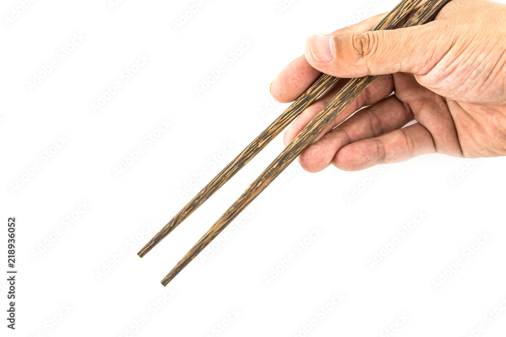 Wooden chopsticks in hand isolated on white