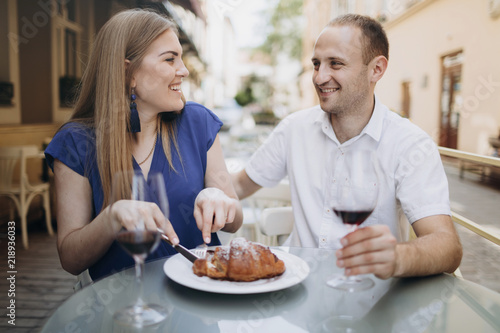 Cheerful couple in a restaurant with glasses of red wine.  Young