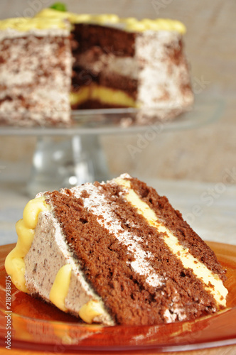 A piece of lemon-chocolate cake on an orange plate