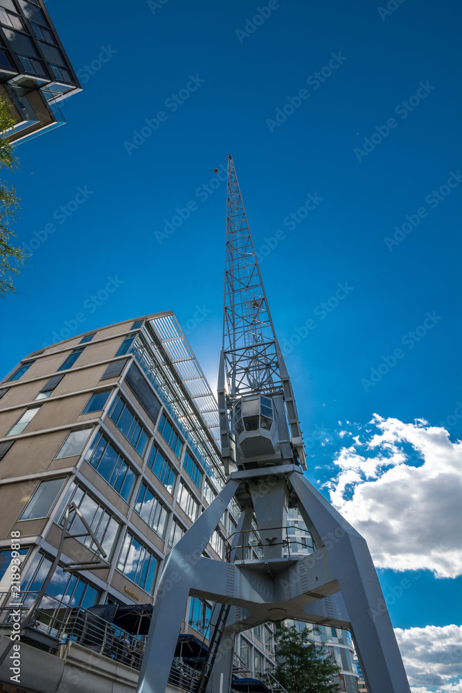 Obraz premium View of the construction crane in the Hamburg Hafencity. HafenCity quarter in the district of Hamburg Mitte on the Elbe river island Grasbrook.