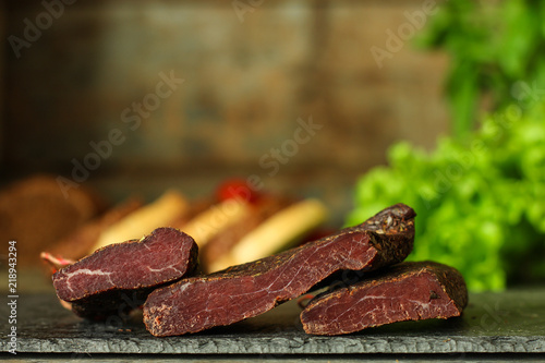 salami, salted meat jerky - sliced ​​with slices (venison) . food background.  Top view with copy space