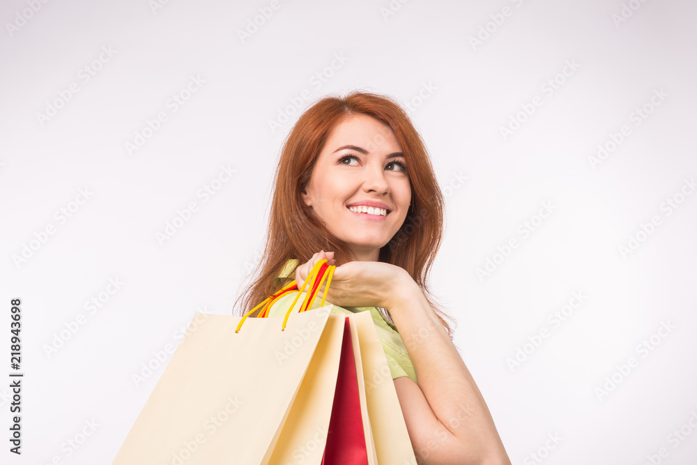 Consumer, sale and people concept - Style redhead woman holding shopping bags Consumer, sale and people concept - Style redhead woman holding shopping bags