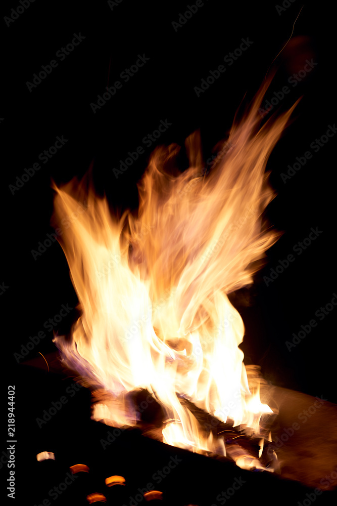 Fire flames on a black background. The fire burns on a black background. Fire flames on a black background. The fire burns on a black background.
