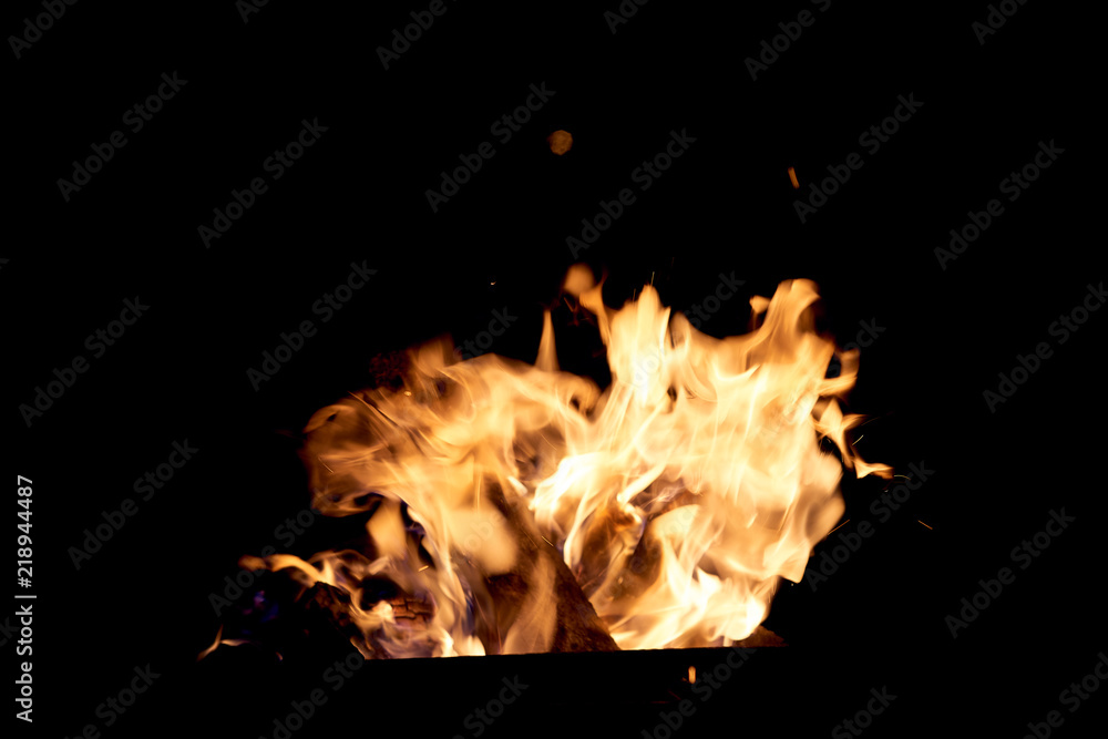 Fire flames on a black background. The fire burns on a black background. Fire flames on a black background. The fire burns on a black background.