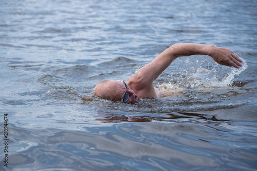 Elderly man swims