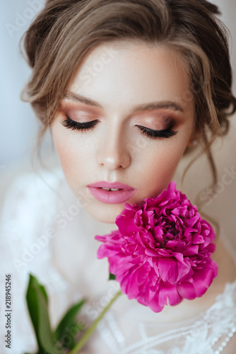 Beautiful model girl with flowers peony