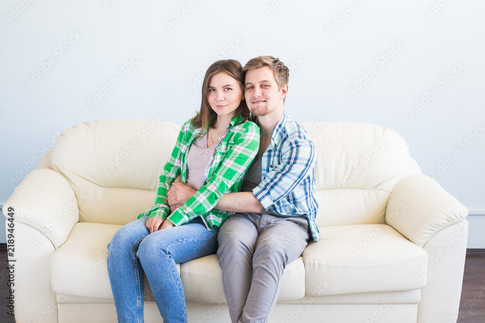 Young couple having fun laughing and hugging on sofa Young couple having fun laughing and hugging on sofa