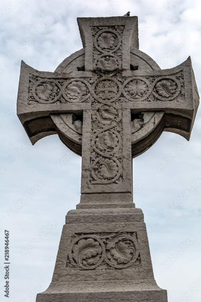 Barcelona, Spain - May 10, 2018: Celtic cross of the Poblenou cemetery. The Cross (1888) is a monumental cross pattée in Celtic style and is dedicated to the anonymous dead of the cemetery. Barcelona, Spain - May 10, 2018: Celtic cross of the Poblenou cemetery. The Cross (1888) is a monumental cross pattée in Celtic style and is dedicated to the anonymous dead of the cemetery.