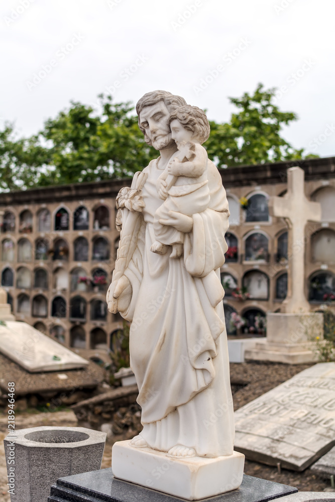 Sepulchral sculpture on grave in Poblenou Cemetery. Peaceful but macabre, cemetery of Poblenou is today home to incredible sculptures, haunting, yet beautiful.