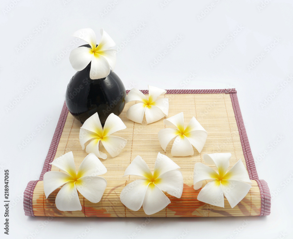 White flowers on bamboo sheets . White flowers on bamboo sheets .