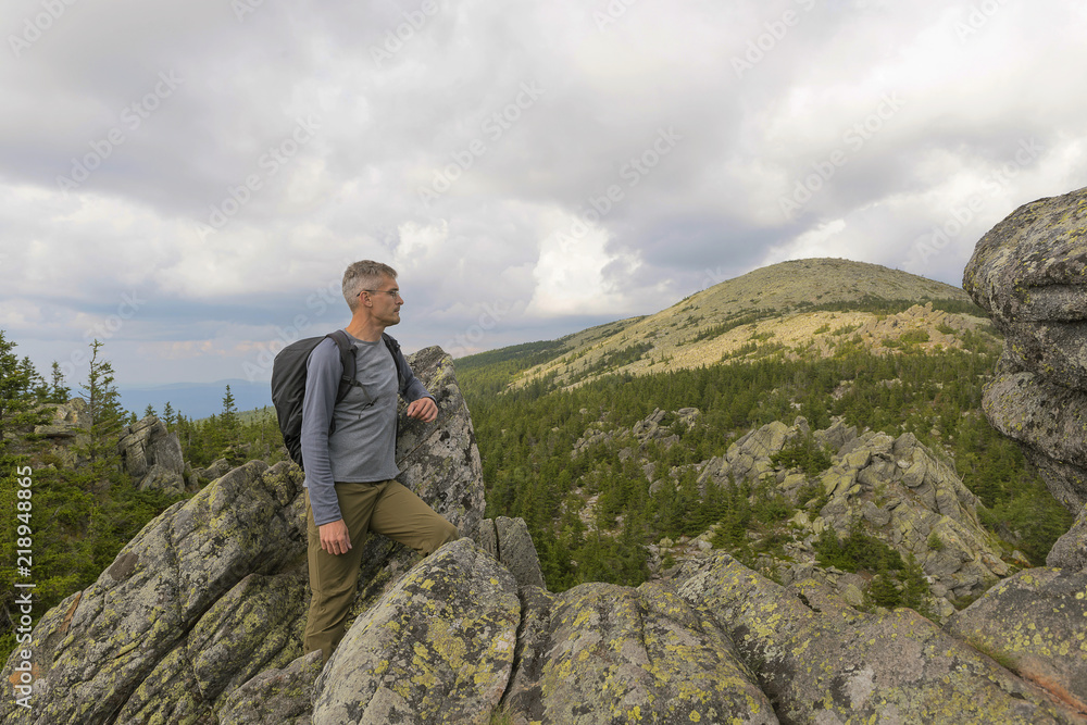 Man hiker on a top of a mountain in the national park of nature Taganay, Russia Man hiker on a top of a mountain in the national park of nature Taganay, Russia