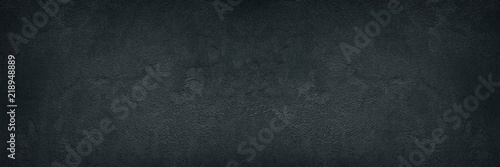 Black rough concrete wall wide texture - dark grunge background