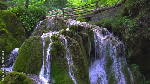 Beautiful unique Bigar Waterfall in Romania on the Edge of the Road passing through the carpatian Mountains